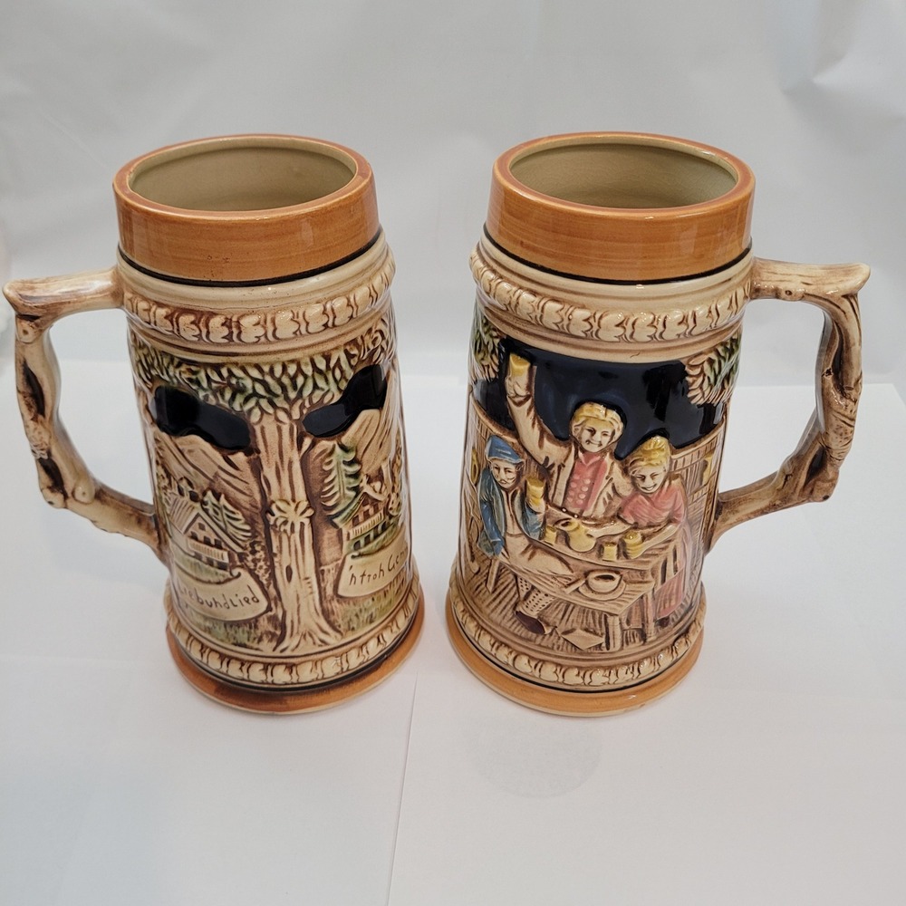 Vintage Japan Beer Stein Set of 2 German Relief Scene Ceramic Mugs 7 Inch